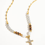 Load image into Gallery viewer, Necklace with beads and a cross pendant on a white background