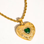 Load image into Gallery viewer, Gold heart-shaped pendant with a green gemstone on a white background