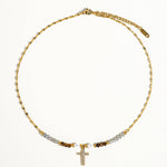 Load image into Gallery viewer, Gold necklace with beads and a cross pendant on a white background