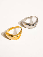 Load image into Gallery viewer, Two gold and silver rings on a white background
