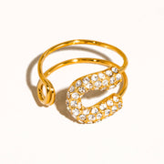 Gold ring with crystal embellishments on a white background