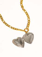 Gold chain necklace with two heart-shaped pendants on a white background