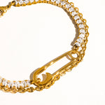 Load image into Gallery viewer, Gold bracelet with safety pin design and clear stones on a white background
