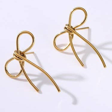 Gold bow-shaped earrings on a white background