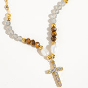 Necklace with beads and a cross pendant on a white background