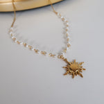 Load image into Gallery viewer, Gold necklace with a sun-shaped pendant on a light gray background
