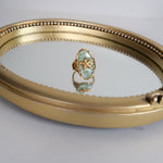 Load image into Gallery viewer, Gold ring with a green gemstone on a reflective surface

