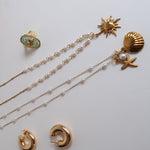 Load image into Gallery viewer, Gold jewelry set including necklace, earrings, and ring on a white surface with a gold mirror.
