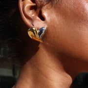 Close-up of a person wearing a leopard print top with a focus on the shoulder and arm.