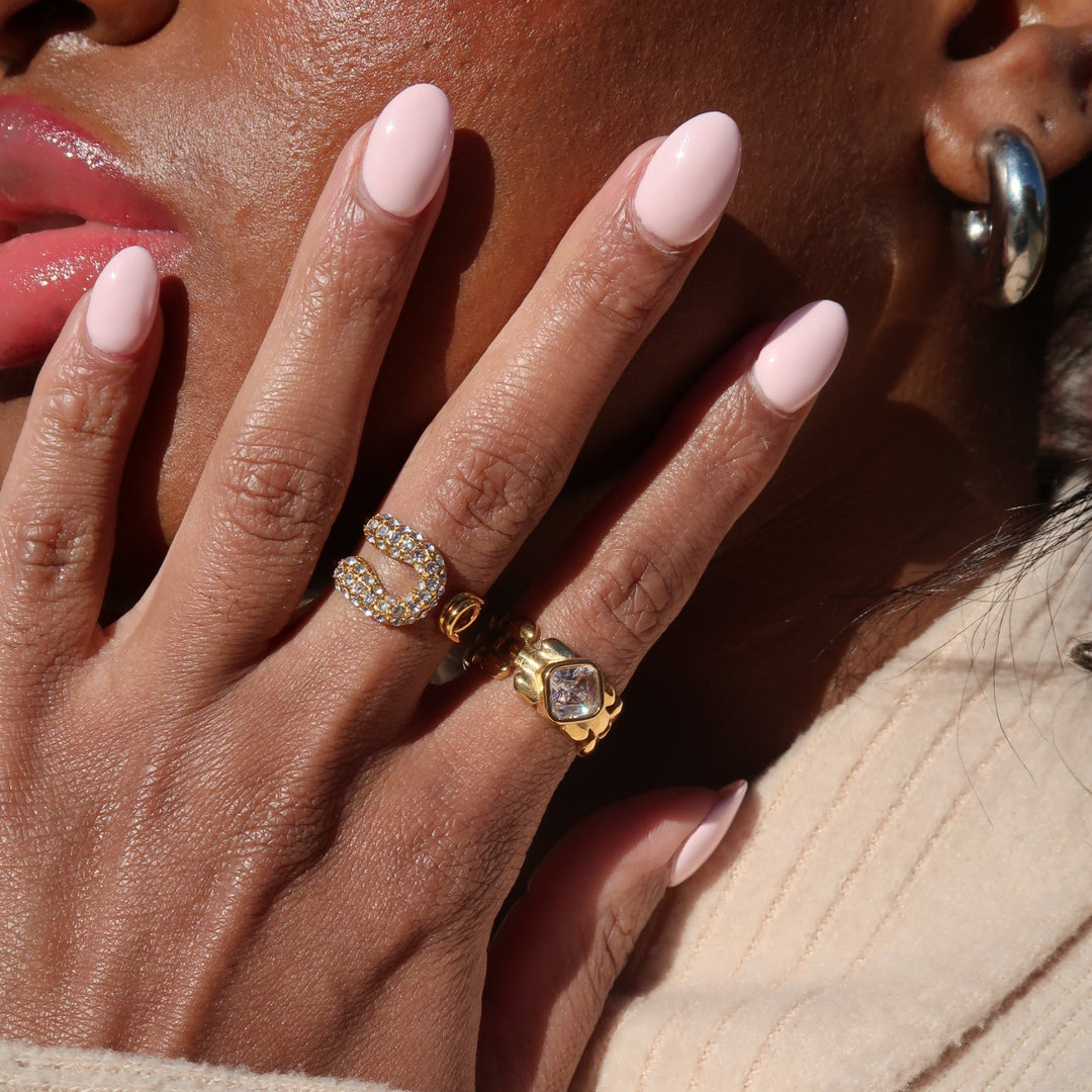 Close-up of a hand with gold rings