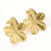 Pair of gold flower-shaped earrings on a white background
