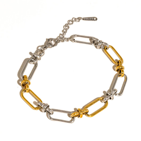 Bracelet with gold and silver links on a white background