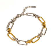Bracelet with gold and silver links on a white background