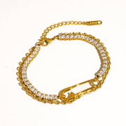 Gold bracelet with clear stones on a white background