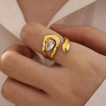 Load image into Gallery viewer, Gold ring with a clear gemstone on a hand against a neutral background