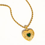 Load image into Gallery viewer, Gold heart-shaped pendant with a green gemstone on a white background